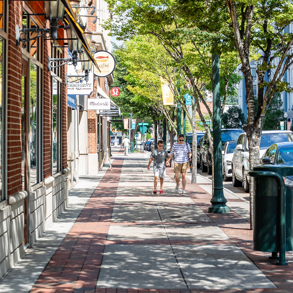 Parent and child walking down sidewalk at Town Center in Virginia Beach